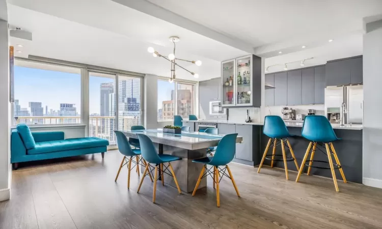 Dining space with a chandelier and light hardwood / wood-style floors