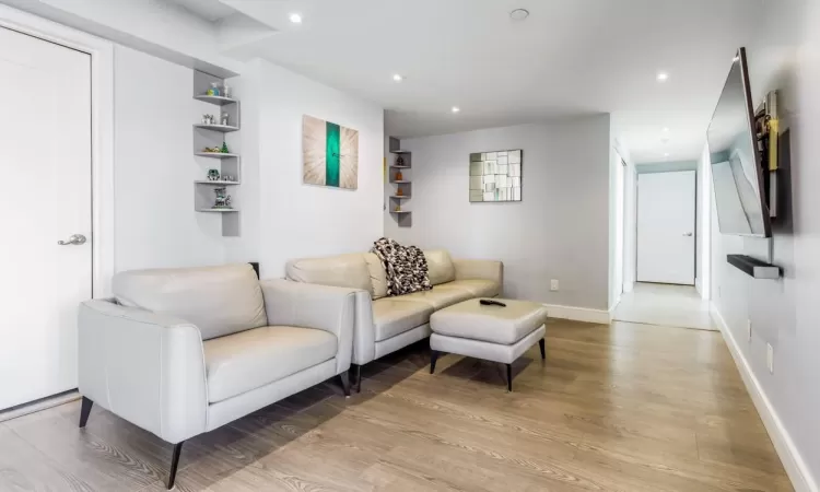 Living room with light hardwood / wood-style flooring