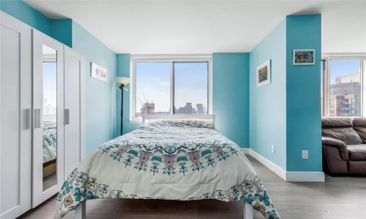 Bedroom featuring hardwood / wood-style floors and multiple windows