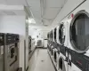 Clothes washing area with stacked washing maching and dryer and washing machine and dryer