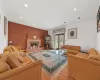 Living room featuring a premium fireplace and light hardwood / wood-style flooring