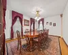 Dining area with light hardwood / wood-style floors, plenty of natural light, and a chandelier