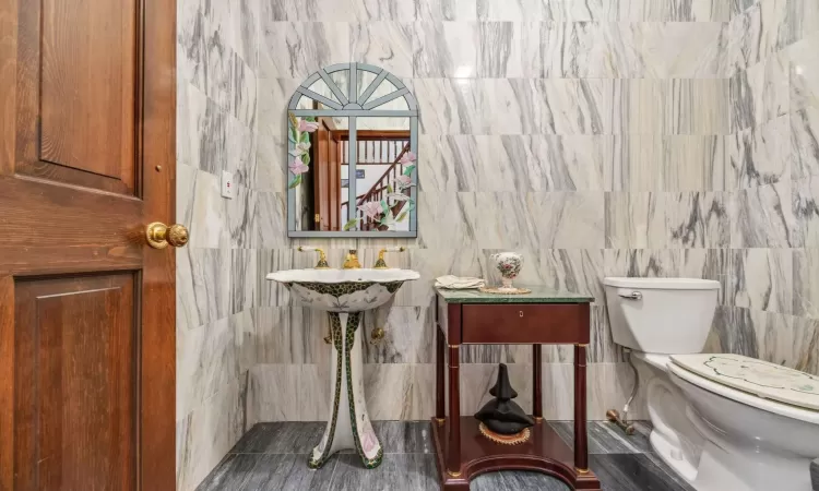 Bathroom with tile walls and toilet