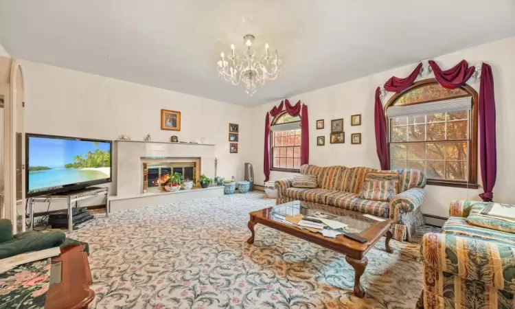 Carpeted living room featuring an inviting chandelier