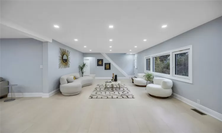 Living room with light hardwood / wood-style floors