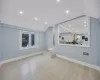 Living room with vaulted ceiling and light hardwood / wood-style flooring