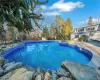 View of swimming pool featuring an in ground hot tub and a patio