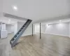 Basement featuring washing machine and dryer and light hardwood / wood-style floors