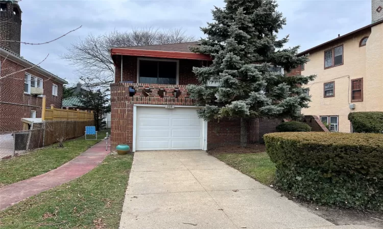 View of front facade featuring a garage