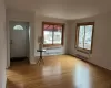 Entryway featuring light hardwood / wood-style floors, crown molding, and radiator