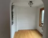 Empty room with radiator and light wood-type flooring