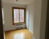 Spare room with light hardwood / wood-style floors and radiator heating unit