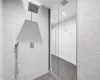 Lower Level Bathroom featuring a shower with shower door and tile patterned flooring and dressing cabana area