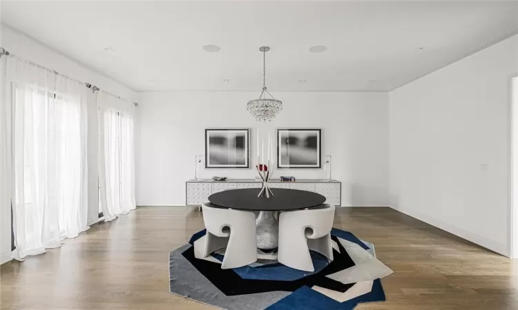 Dining room featuring dark hardwood / wood-style floors and a notable chandelier