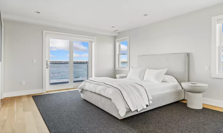 Bedroom with hardwood / wood-style flooring and access to exterior