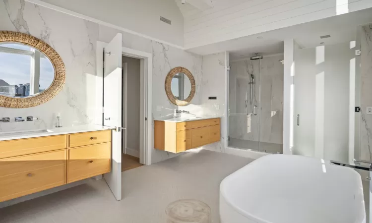 Bathroom featuring high vaulted ceiling, independent shower and bath, and vanity