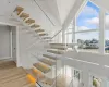 Stairway with lofted ceiling and wood-type flooring