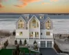 View of front facade with a garage and a water view