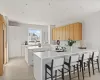 Kitchen featuring sink, kitchen peninsula, a kitchen island, and white cabinetry