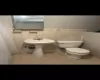 Bathroom with tile walls, tile patterned flooring, and toilet