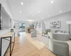 Living room featuring an inviting chandelier and light wood-type flooring