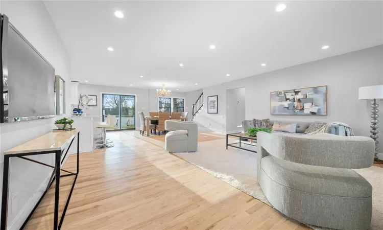 Living room featuring an inviting chandelier and light wood-type flooring