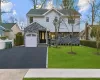 View of front of house with a front lawn and a garage