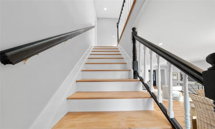 Staircase featuring hardwood / wood-style flooring