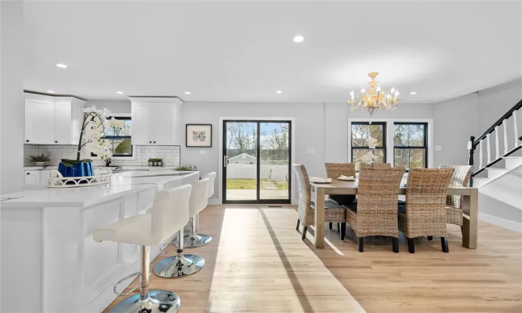 Dining space featuring a chandelier and light wood-type flooring