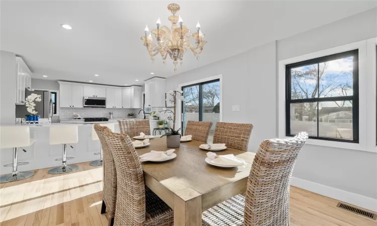 Dining room featuring light hardwood / wood-style floors and an inviting chandelier