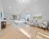 Bedroom with an inviting chandelier, vaulted ceiling, and light hardwood / wood-style flooring