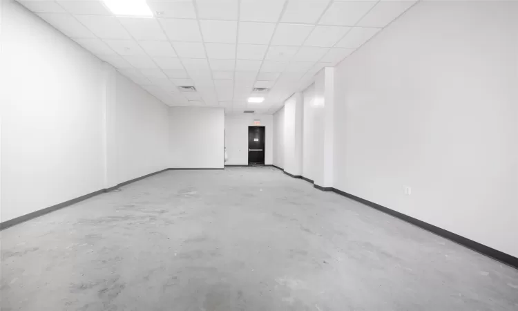 Empty room with a drop ceiling