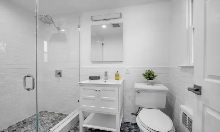 Newly renovated primary bath with frameless stall shower and rain shower head