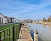 View of dock featuring a water view and a lawn