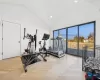 Exercise room with high vaulted ceiling and parquet floors