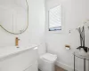 Bathroom with toilet, vanity, and tile patterned flooring