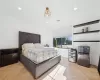 Bedroom featuring light parquet flooring and stainless steel refrigerator