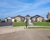 View of front of property with a front lawn and a garage