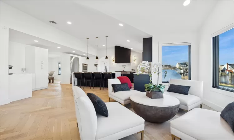 Living room featuring lofted ceiling and light parquet flooring