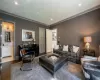 Living room featuring crown molding and dark hardwood / wood-style floors