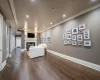 Living room with ornamental molding and dark wood-type flooring