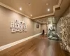 Exercise area featuring ornamental molding and dark wood-type flooring