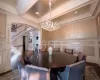 Dining area featuring beamed ceiling, an inviting chandelier, ornamental molding, and dark hardwood / wood-style flooring