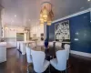 Dining room featuring sink, ornamental molding, and dark hardwood / wood-style floors