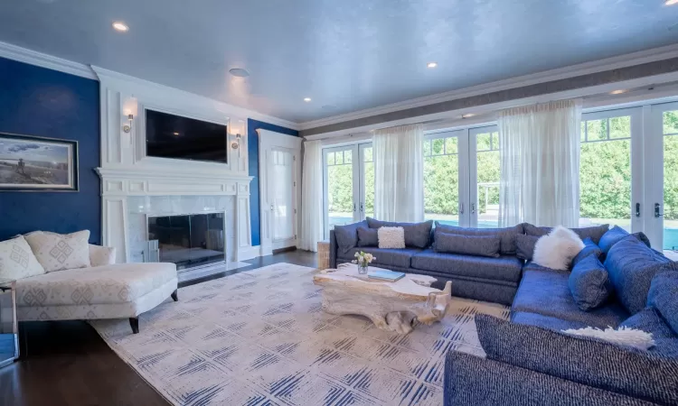 Living room featuring french doors, ornamental molding, and hardwood / wood-style flooring