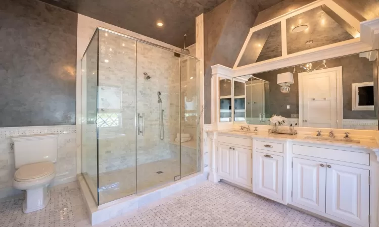 Bathroom with toilet, walk in shower, tile patterned flooring, a towering ceiling, and vanity