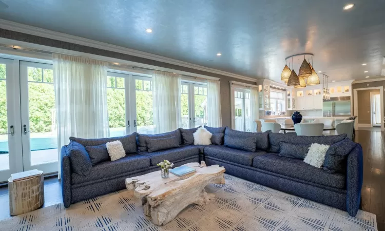 Living room featuring french doors, crown molding, and light hardwood / wood-style floors