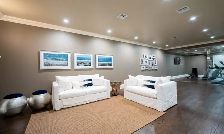 Living room with dark hardwood / wood-style flooring and crown molding