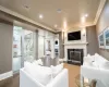 Living room featuring dark wood-type flooring and crown molding