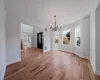 Unfurnished dining area featuring light hardwood / wood-style floors and a chandelier